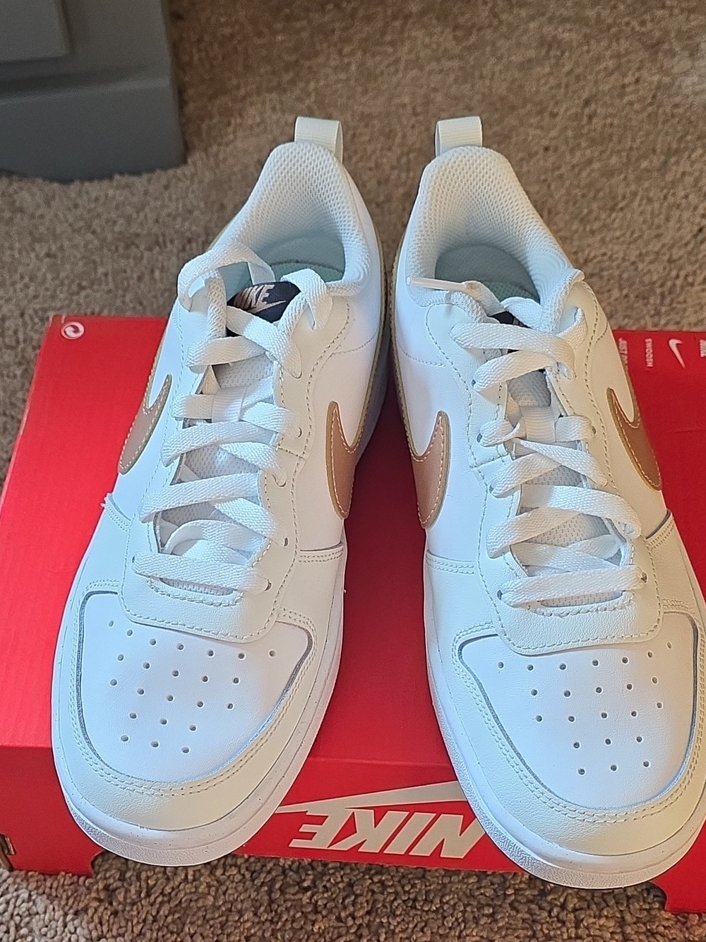 Nike White Sneakers with Gold Swoosh